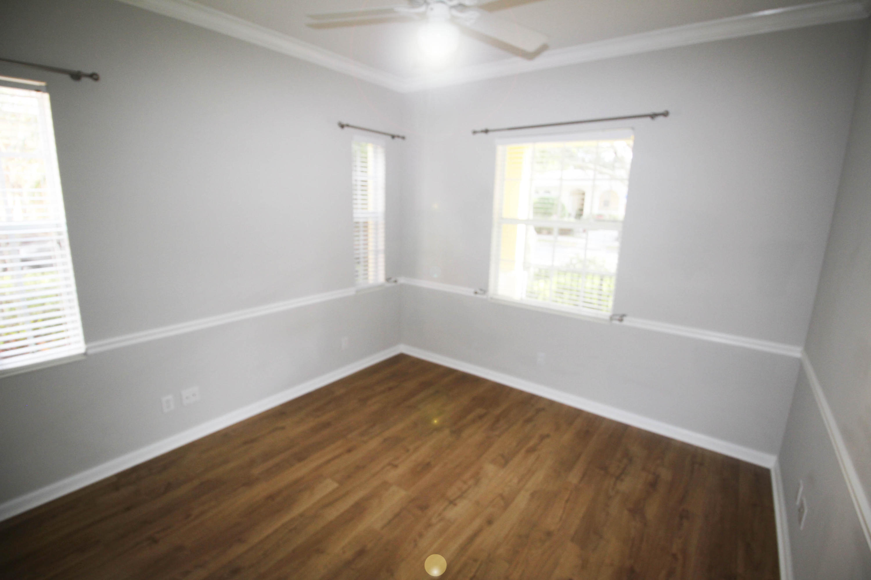 256 San Remo Drive Jupiter, FL 33458 - Photo 17 of 66 a view of an empty room with wooden floor and a window