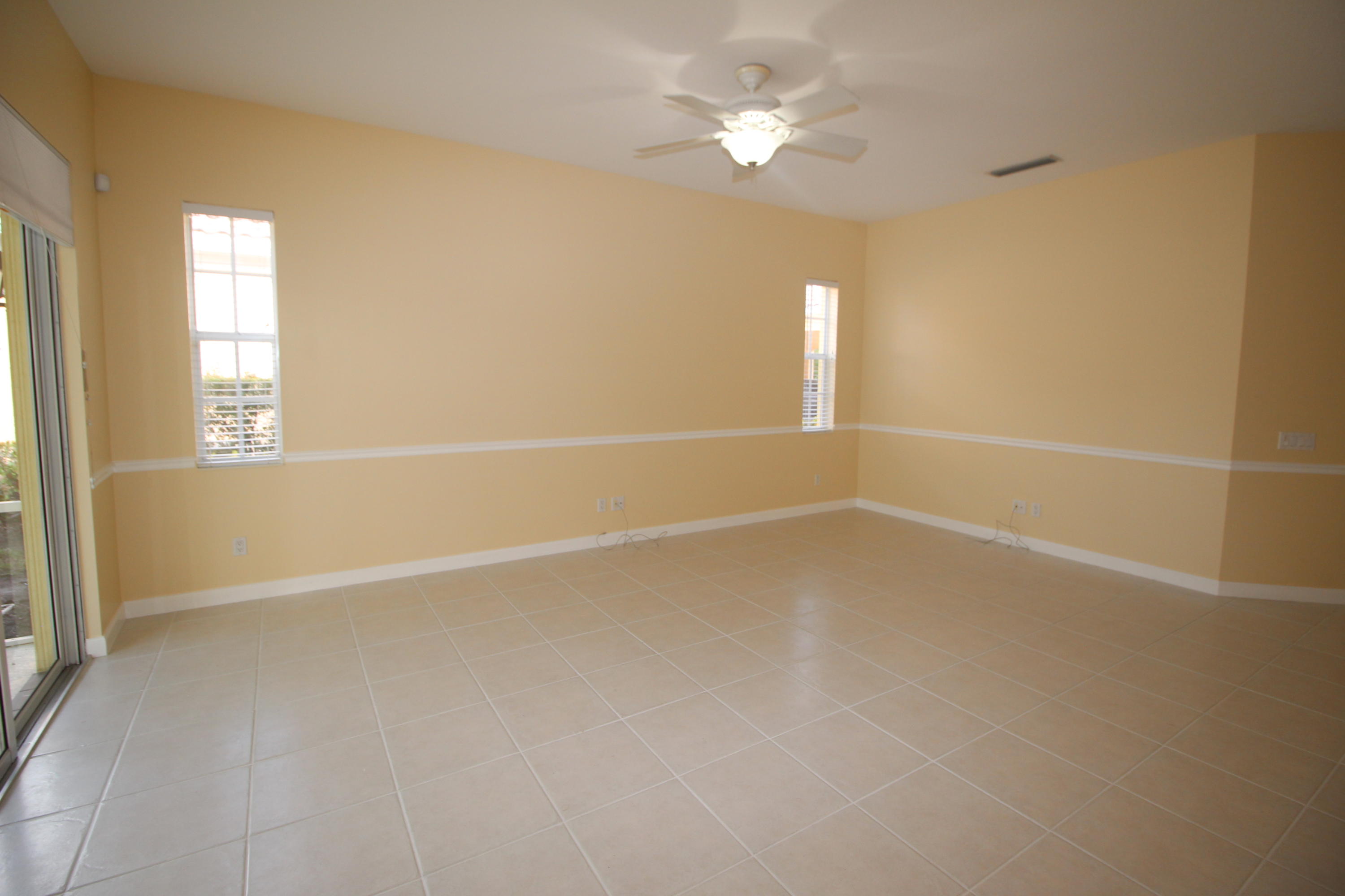 256 San Remo Drive Jupiter, FL 33458 - Photo 23 of 66 an empty room with windows and fan