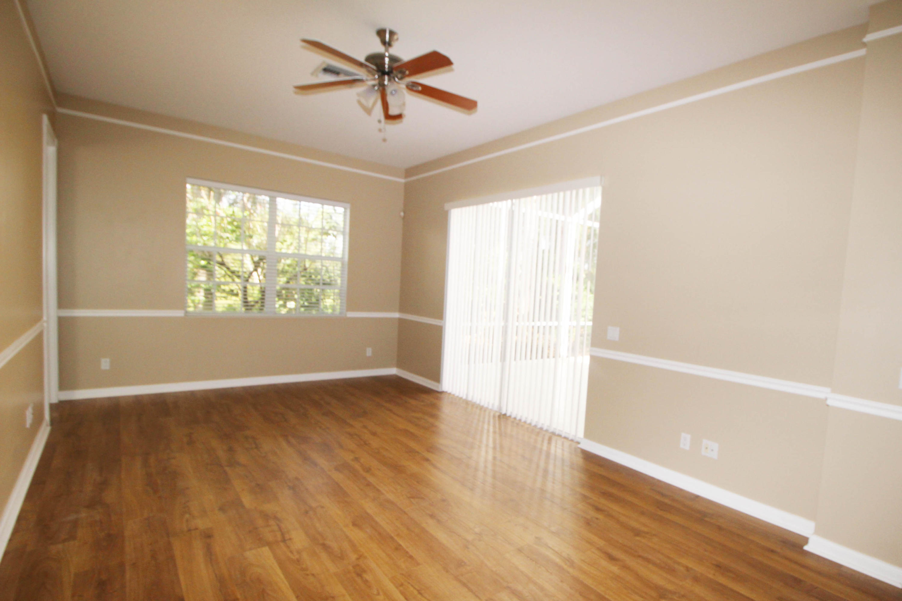 256 San Remo Drive Jupiter, FL 33458 - Photo 25 of 66 wooden floor in an empty room with a window