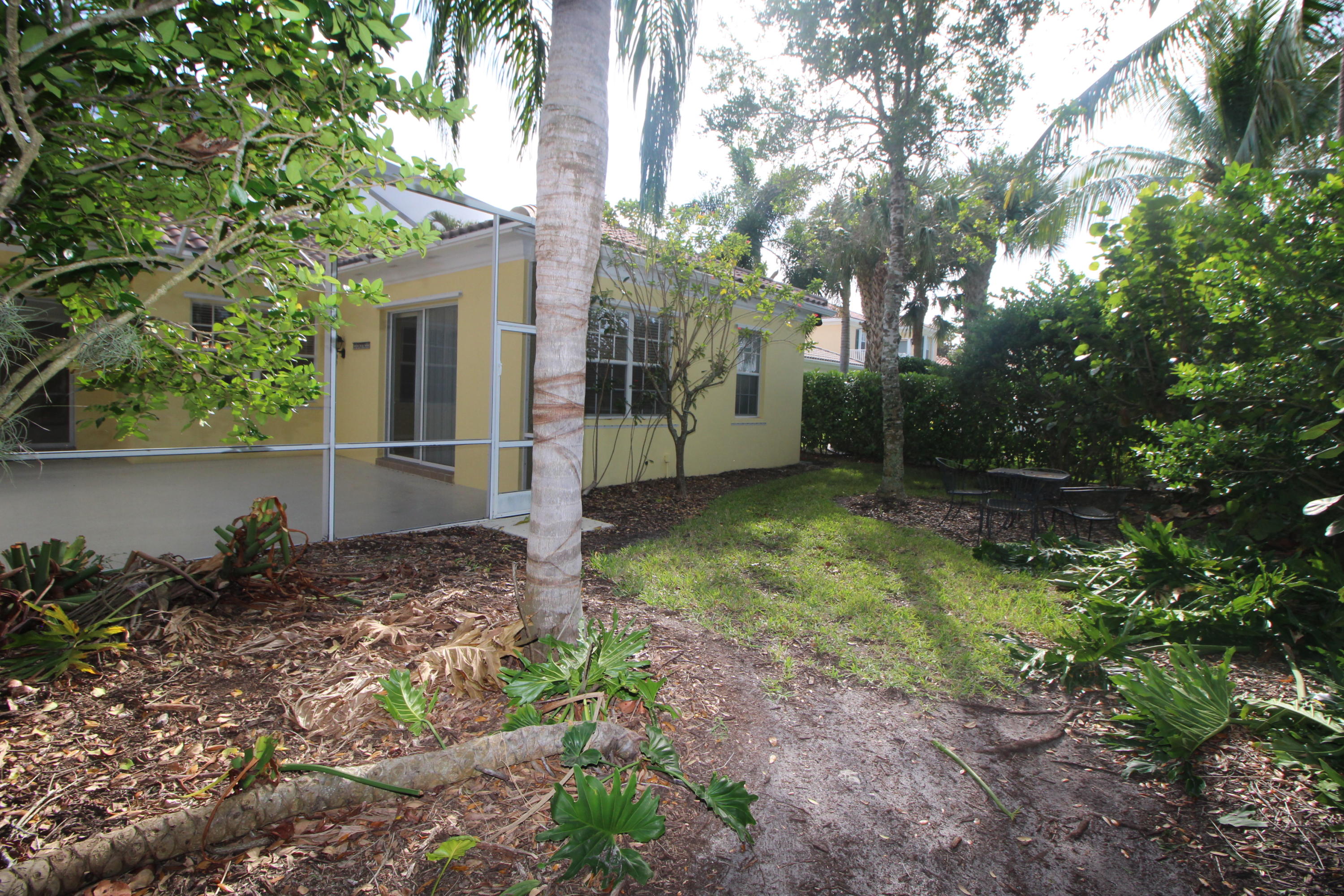 256 San Remo Drive Jupiter, FL 33458 - Photo 36 of 66 a backyard of a house with lots of green space