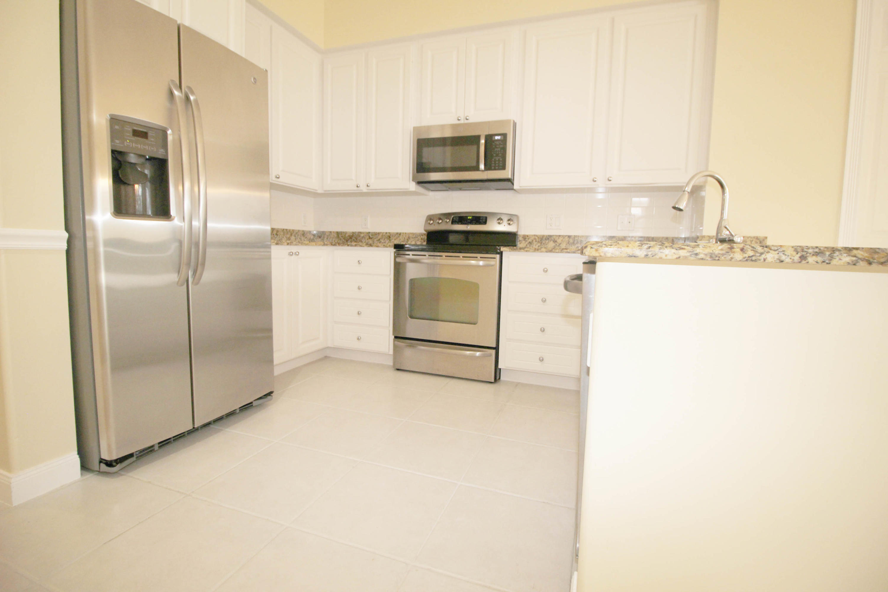 256 San Remo Drive Jupiter, FL 33458 - Photo 43 of 66 a kitchen with stainless steel appliances granite countertop a refrigerator and a stove