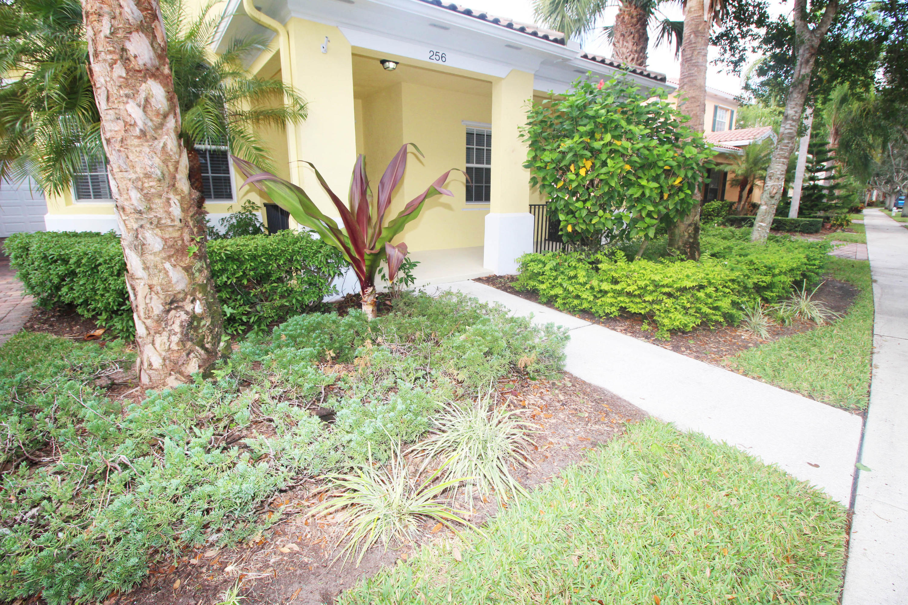 256 San Remo Drive Jupiter, FL 33458 - Photo 52 of 66 a front view of a house with a yard
