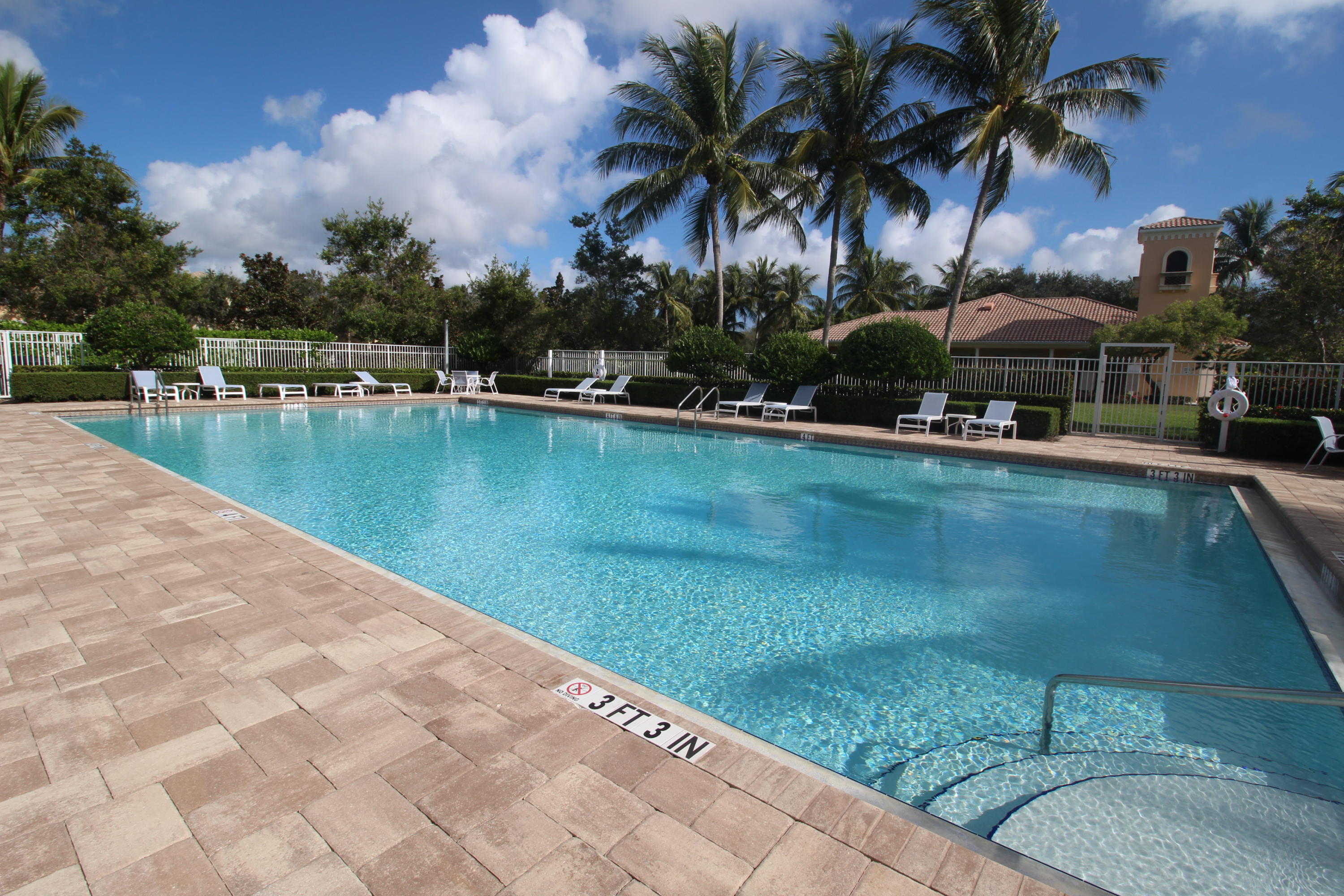 256 San Remo Drive Jupiter, FL 33458 - Photo 57 of 66 a view of a swimming pool with a table and chairs