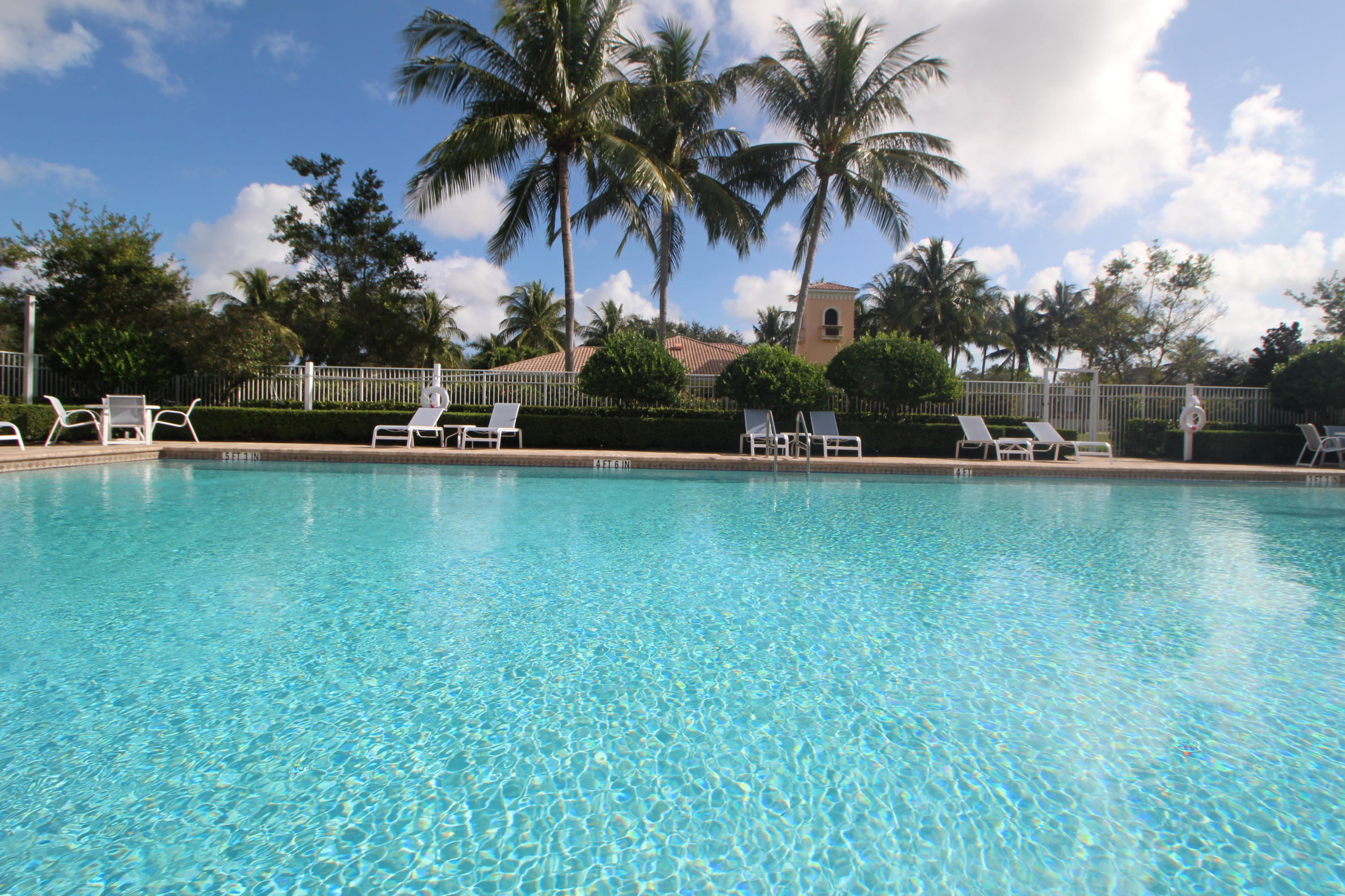 256 San Remo Drive Jupiter, FL 33458 - Photo 60 of 66 a view of a swimming pool with a table and chairs