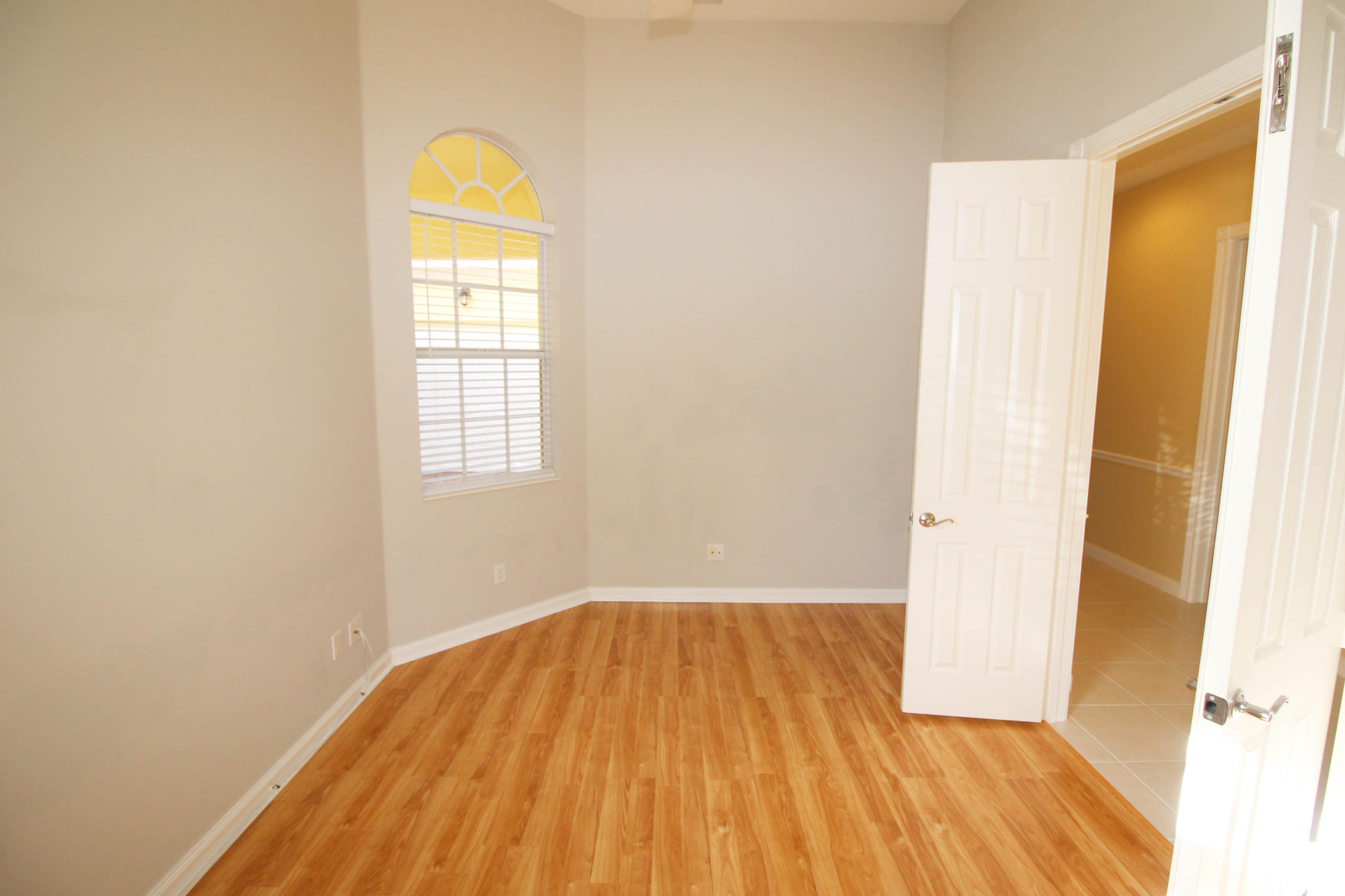 256 San Remo Drive Jupiter, FL 33458 - Photo 8 of 66 a view of empty room with wooden floor and fan