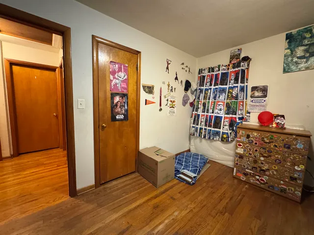 a living room with furniture bookshelf and a window
