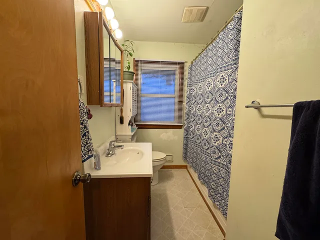 a bathroom with a sink and mirror with shower