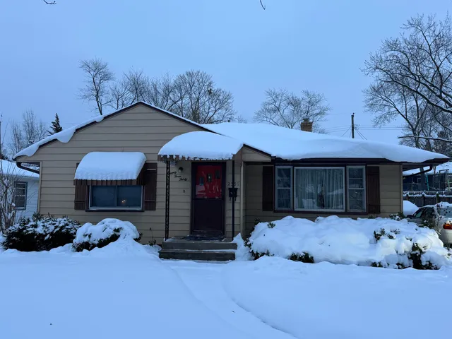 a front view of a house with a yard and glass windows