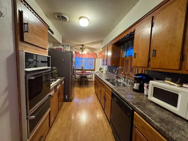 a kitchen with lots of counter top space and stainless steel appliances