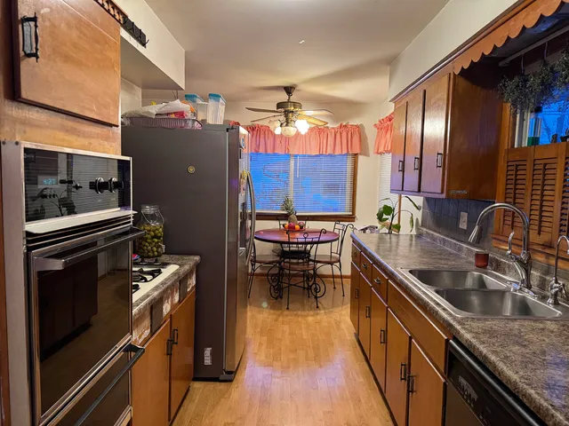 a kitchen with counter top space a sink and appliances