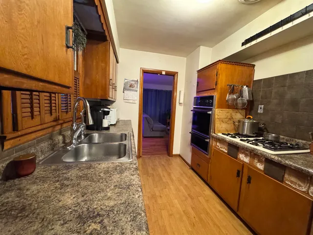 a kitchen with a stove a sink and a refrigerator