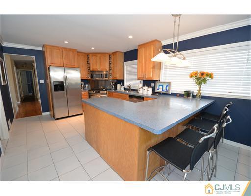 38 Harvard Road Old Bridge, NJ 08859 - Photo 3 of 13 a kitchen with a sink a counter top stainless steel appliances and cabinets