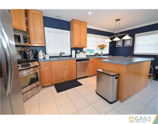 38 Harvard Road Old Bridge, NJ 08859 - Photo 4 of 13 a kitchen with stainless steel appliances granite countertop a stove a sink and a microwave
