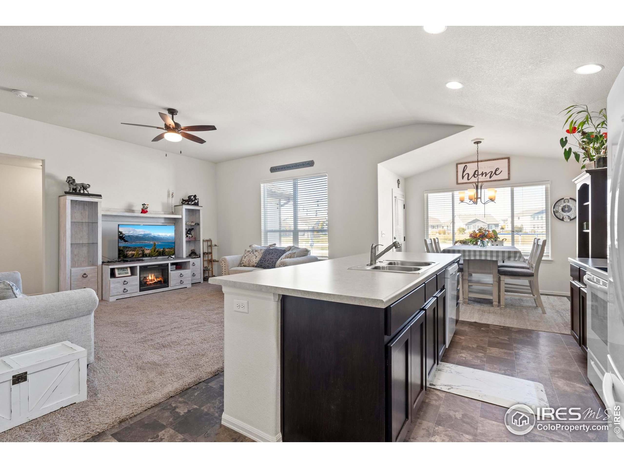 941 Barasingha Street Severance, CO 80550 - Photo 15 of 46 a living room with stainless steel appliances kitchen island furniture and a kitchen view