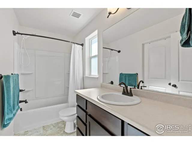 a bathroom with a sink toilet a mirror and shower