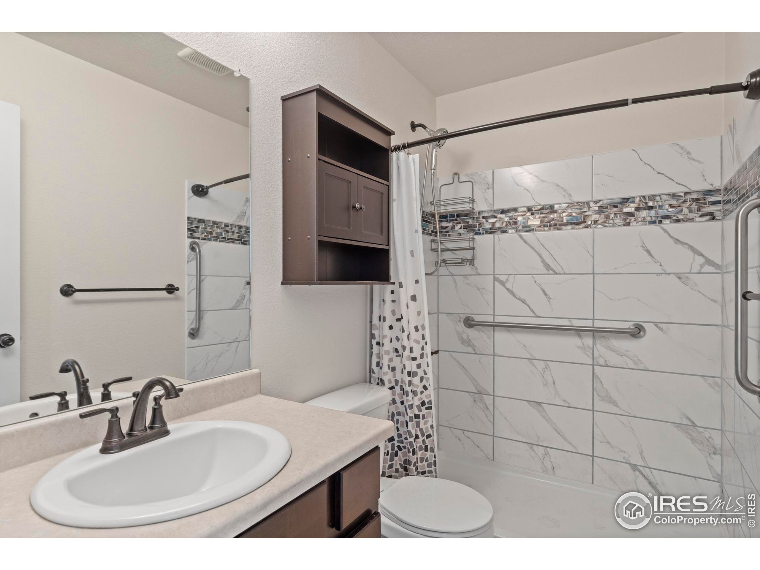 941 Barasingha Street Severance, CO 80550 - Photo 23 of 46 a bathroom with a sink and a mirror