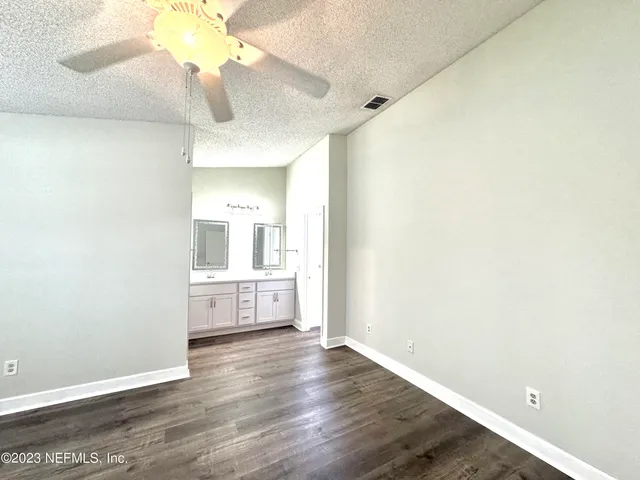 a view of a kitchen with a sink and a refrigerator