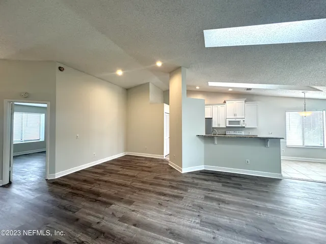 a view of kitchen and kitchen with wooden floor