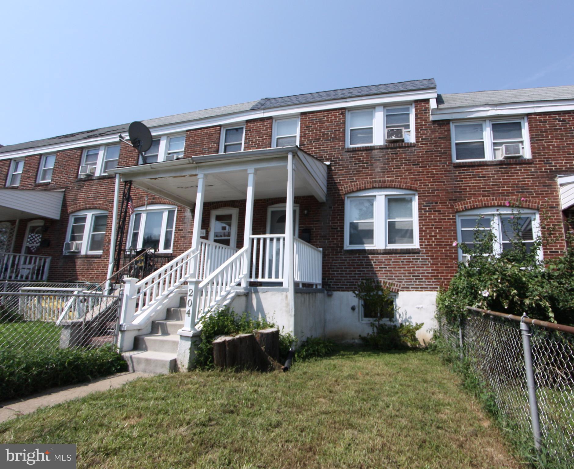 204 Old Riverside Road Baltimore, MD 21225 - Photo 2 of 24 a front view of a house with a yard