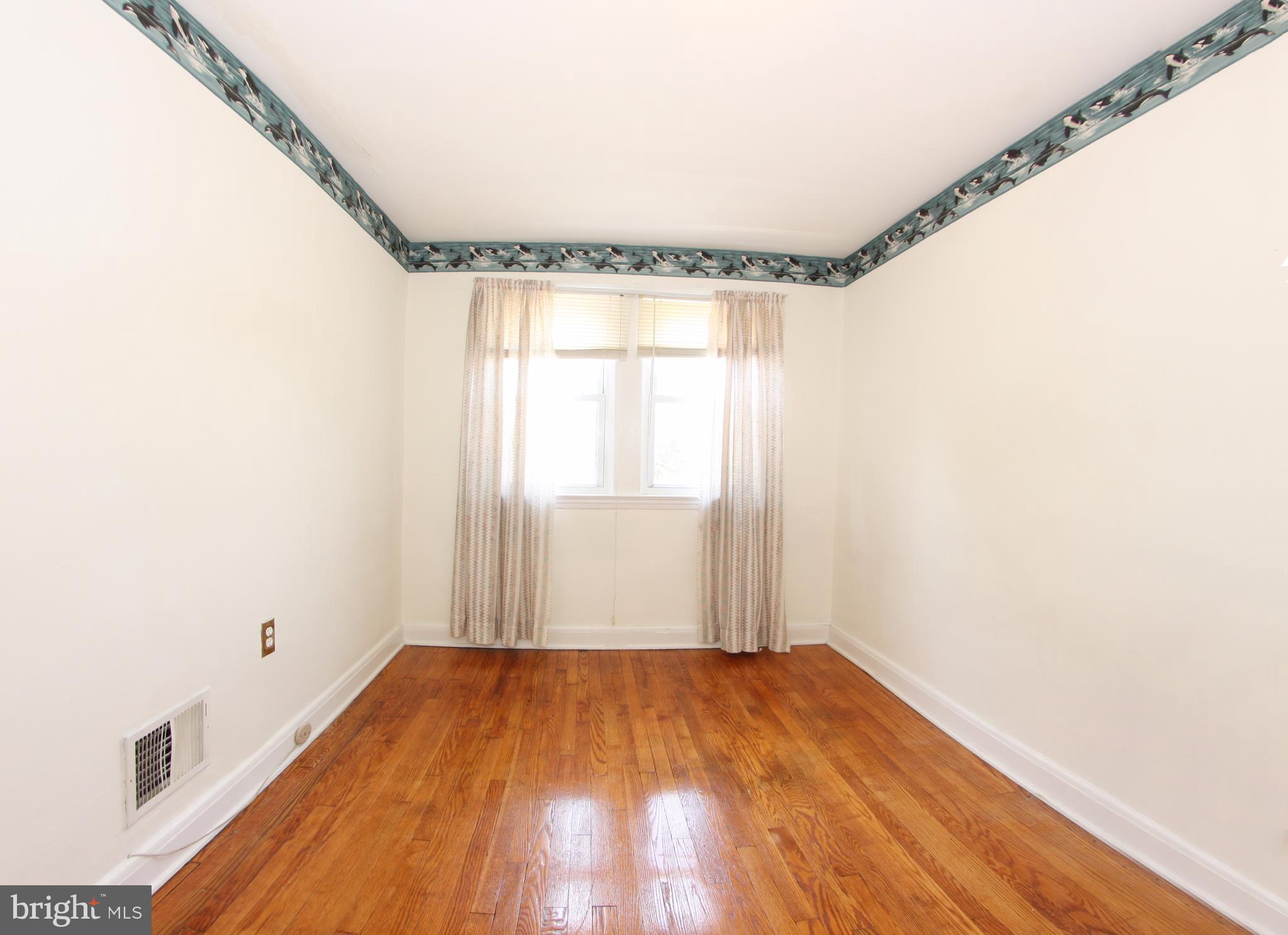 204 Old Riverside Road Baltimore, MD 21225 - Photo 12 of 24 a view of a room with wooden floor and windows