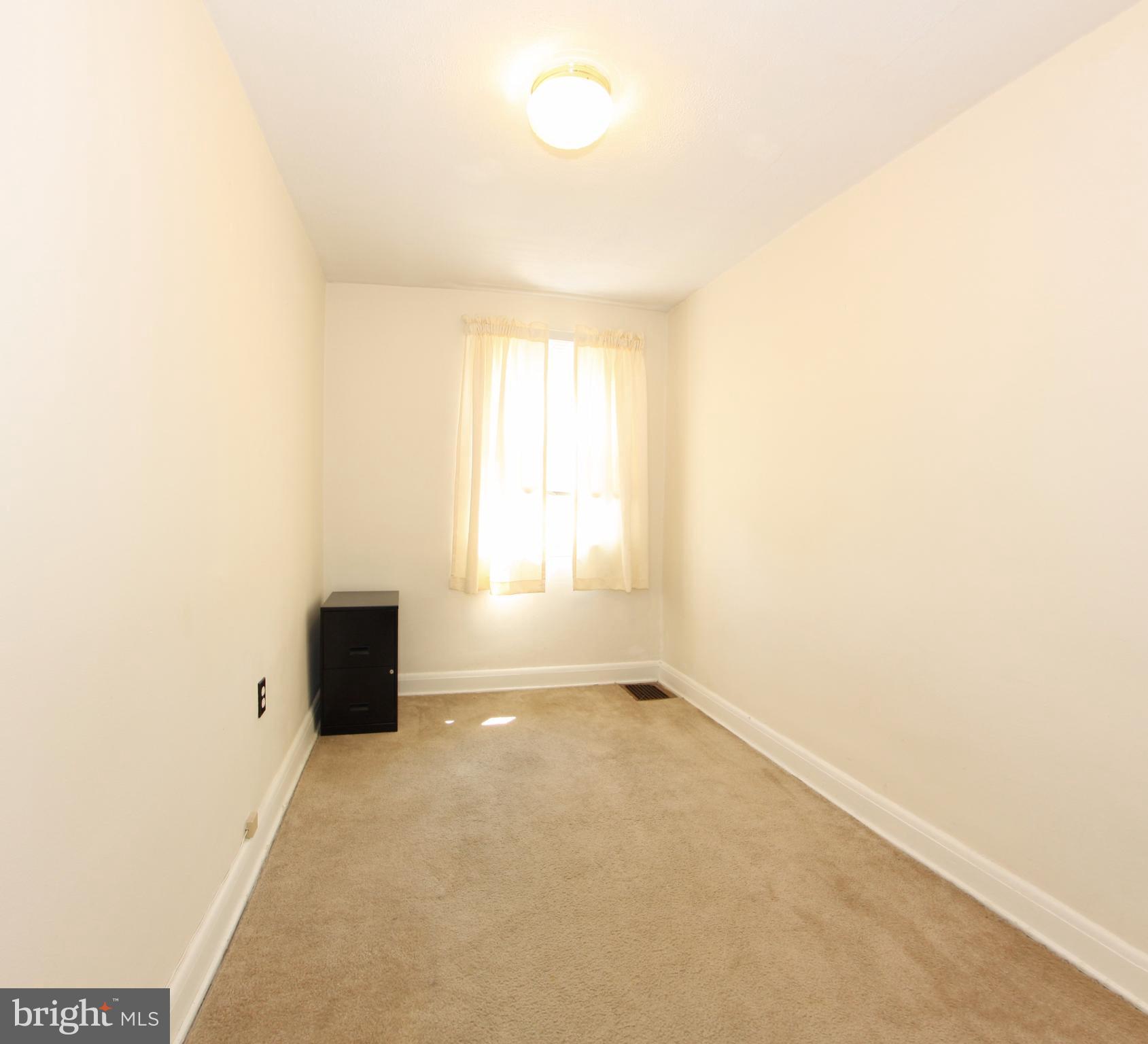204 Old Riverside Road Baltimore, MD 21225 - Photo 13 of 24 a view of an empty room and a window