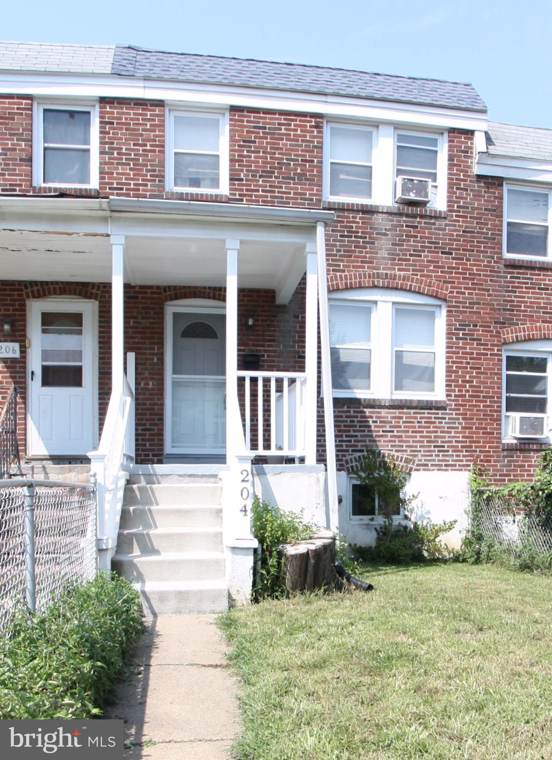 204 Old Riverside Road Baltimore, MD 21225 - Photo 24 of 24 front view of a brick house with a yard