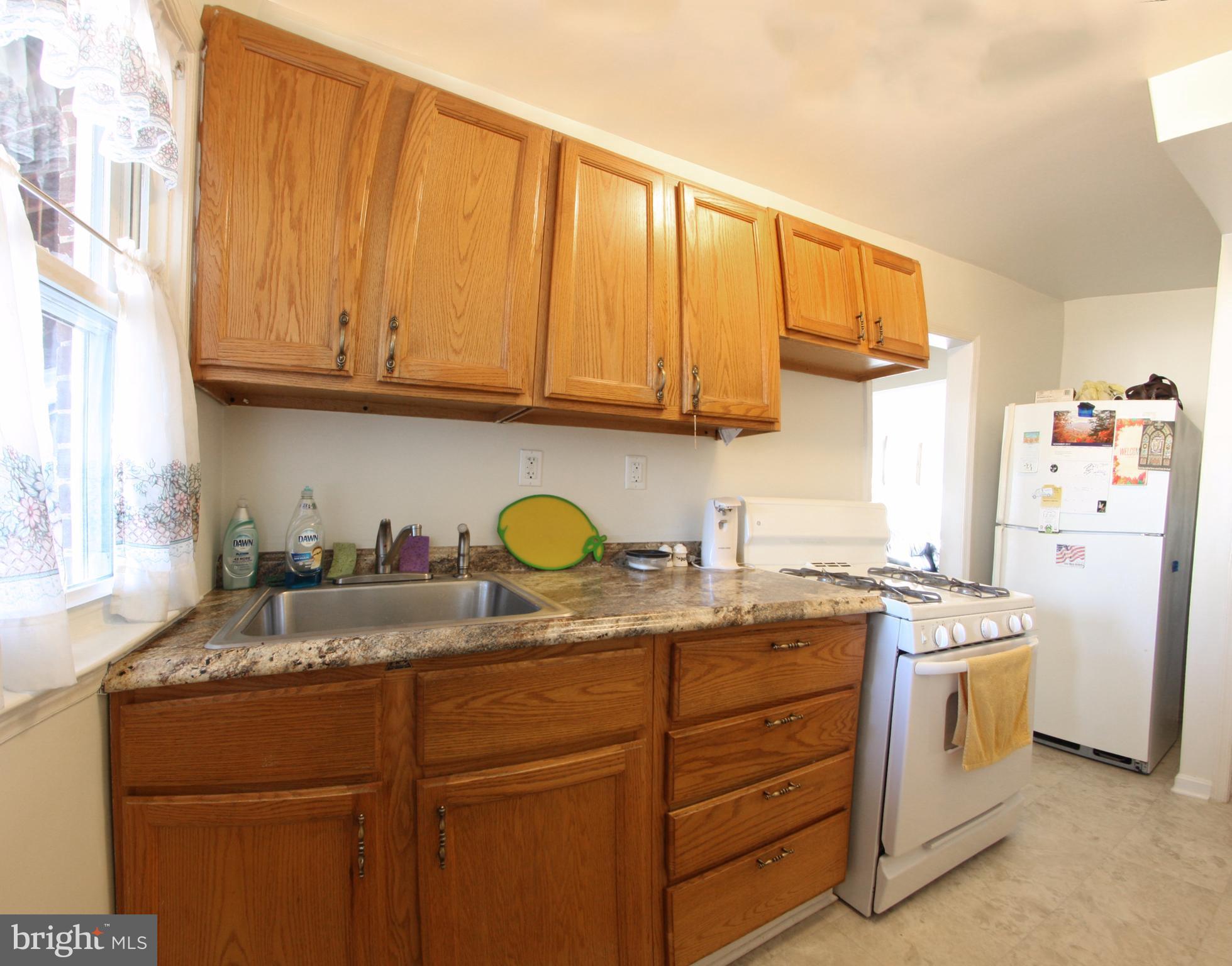 204 Old Riverside Road Baltimore, MD 21225 - Photo 5 of 24 a kitchen with a sink a stove cabinets and wooden floor
