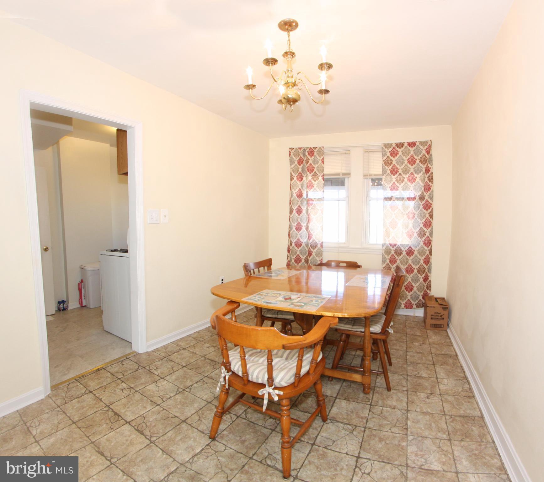 204 Old Riverside Road Baltimore, MD 21225 - Photo 6 of 24 a view of a dining room with furniture and a chandelier