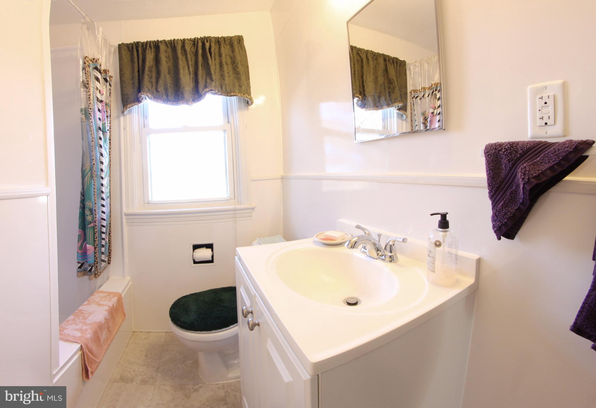 204 Old Riverside Road Baltimore, MD 21225 - Photo 9 of 24 a bathroom with a sink and a mirror