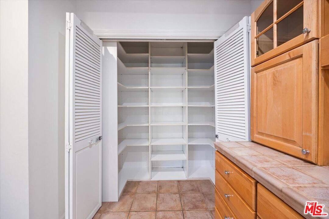14041 Roblar Road Sherman Oaks, CA 91423 - Photo 18 of 47 a view of walk in closet with empty racks