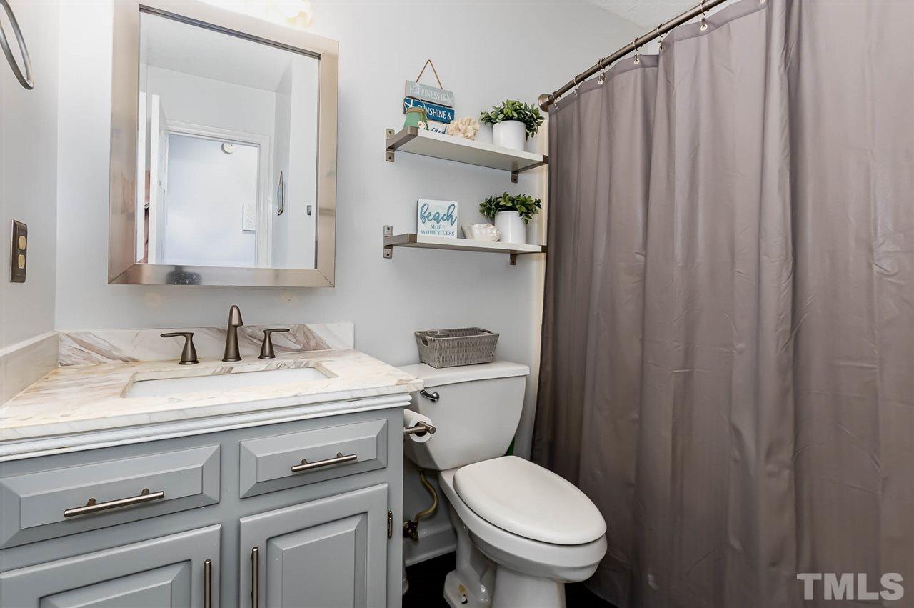113 Tanning Ridge Drive Dunn, NC 28334 - Photo 14 of 28 a bathroom with a granite countertop toilet sink and mirror