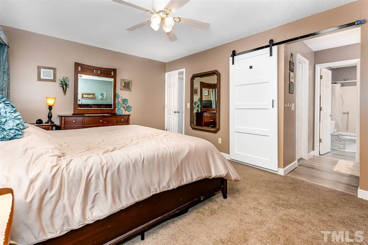113 Tanning Ridge Drive Dunn, NC 28334 - Photo 20 of 28 a bedroom with a bed and a mirror