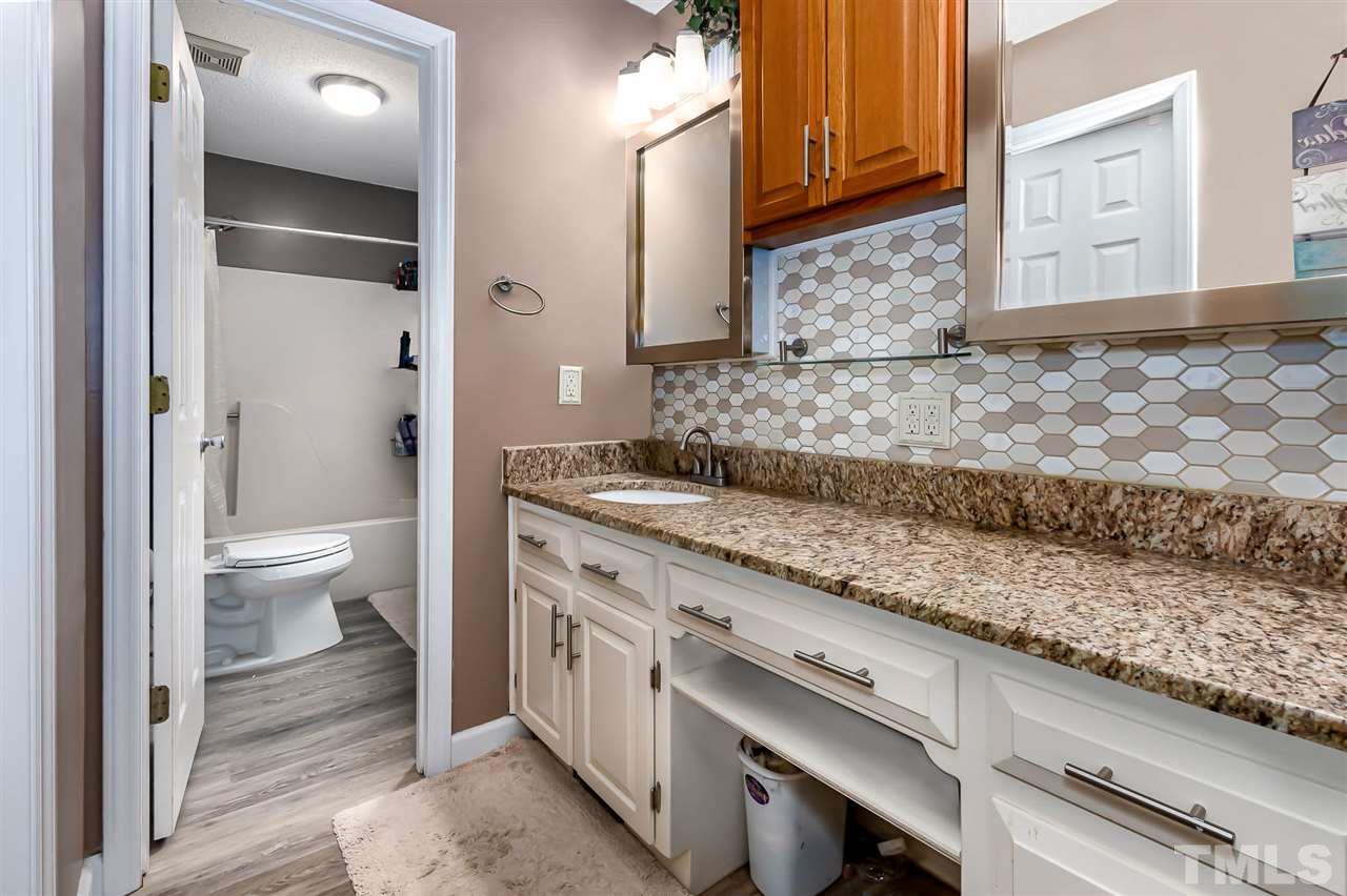 113 Tanning Ridge Drive Dunn, NC 28334 - Photo 21 of 28 a bathroom with a granite countertop sink a toilet and shower