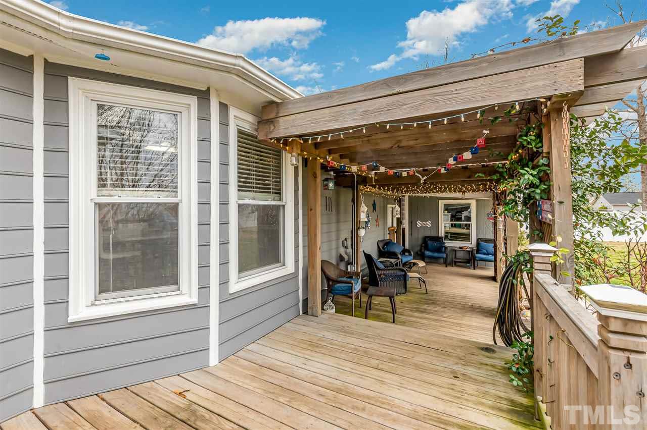 113 Tanning Ridge Drive Dunn, NC 28334 - Photo 24 of 28 a view of a patio with table and chairs and wooden floor