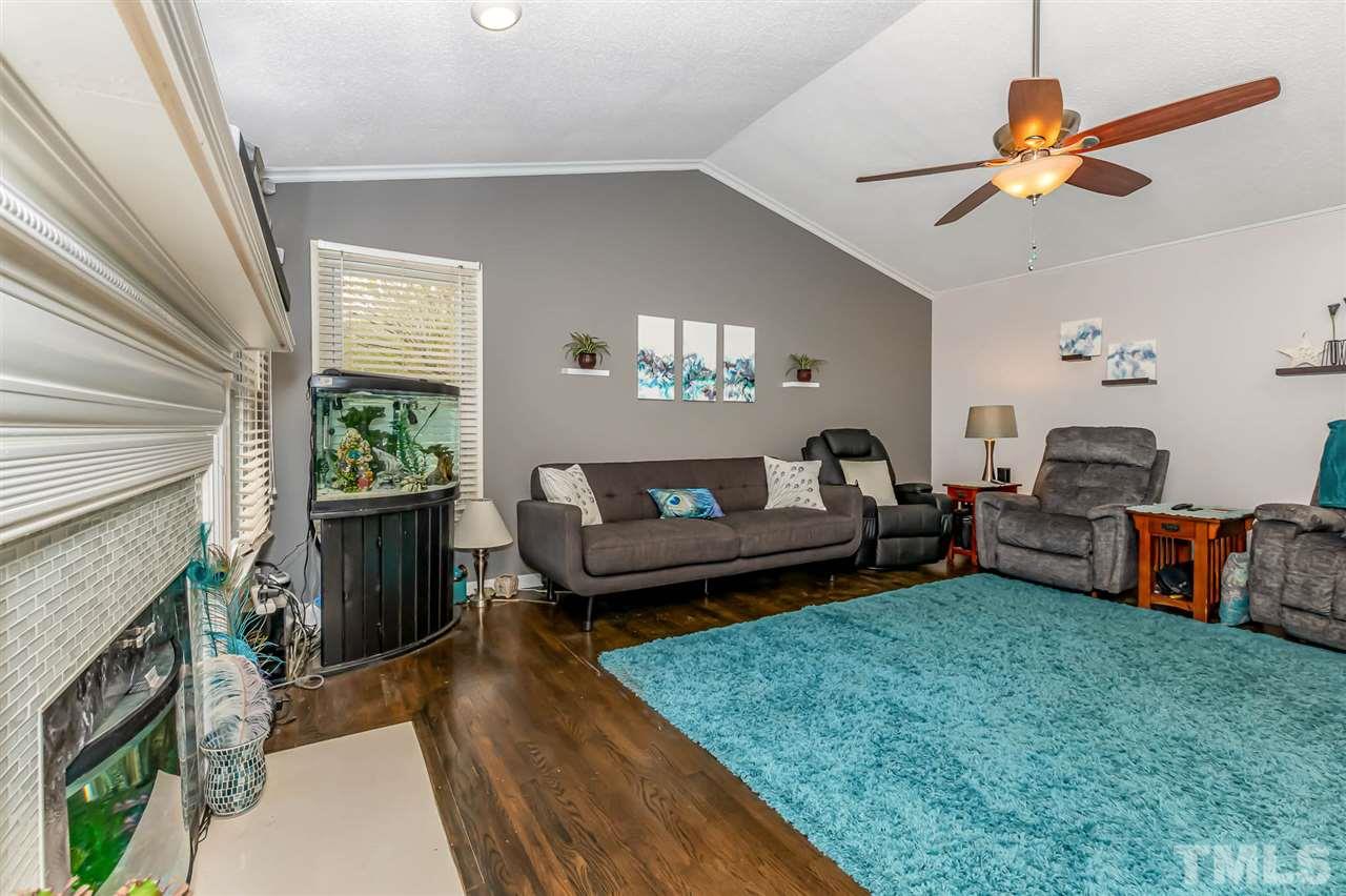 113 Tanning Ridge Drive Dunn, NC 28334 - Photo 9 of 28 a living room with furniture and a fireplace