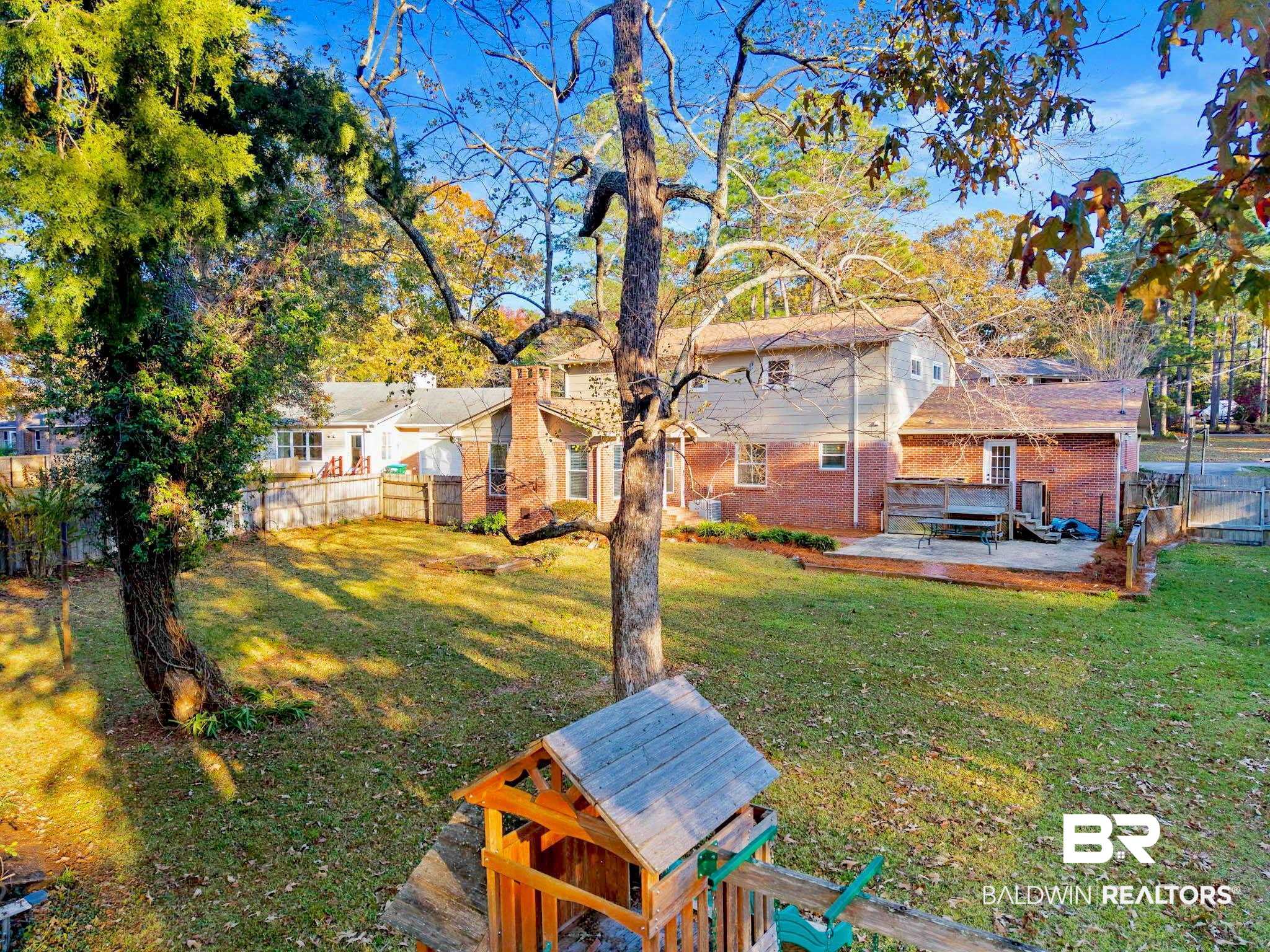 608 Southern Way Daphne, AL 36527 - Photo 35 of 35 Fenced backyard featuring a wooden deck and a jacuzzi
