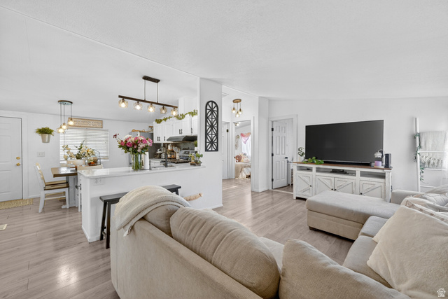 160 Cushing Way Layton, UT 84041 - Photo 1 of 23 Open-concept living area featuring light wood-finish flooring, white walls, and recessed lighting