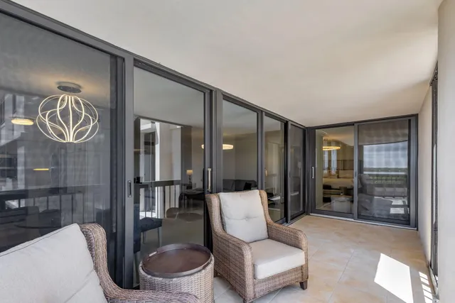 a view of a chair and table in the balcony