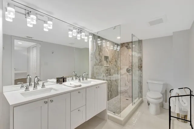 a bathroom with a glass shower door