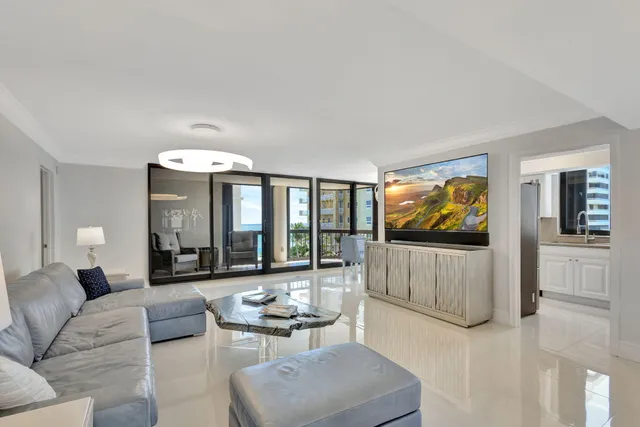 a view of a dining room with furniture and a chandelier