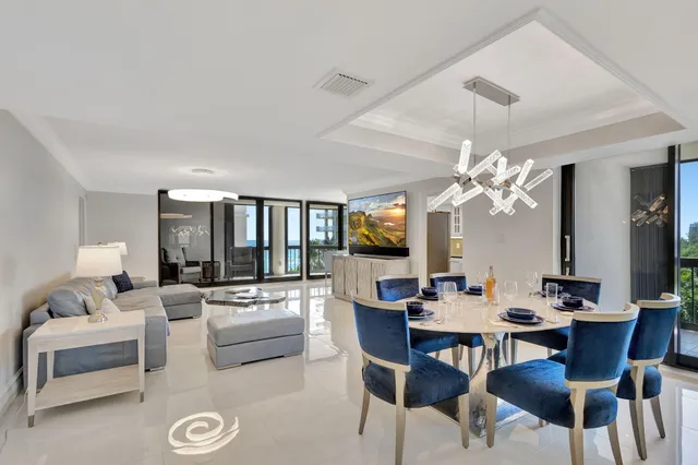 a living room with furniture and large windows