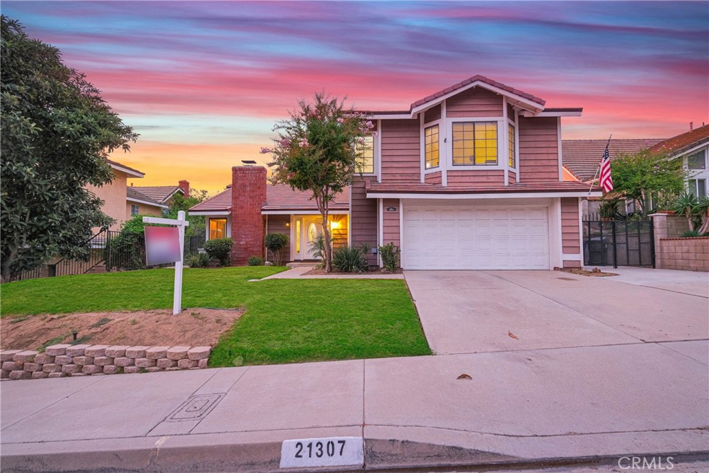21307 Chirping Sparrow Road Diamond Bar, CA 91765 - Photo 1 of 1 a front view of a house with a yard and garage