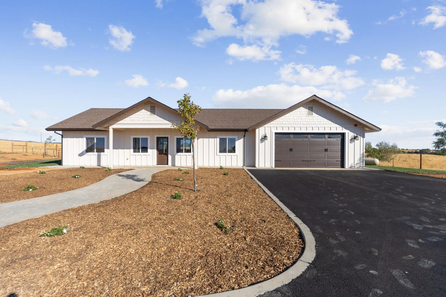 a view of a house with a yard and porch