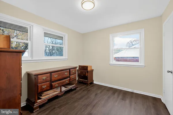 a view of an empty room with furniture and a window