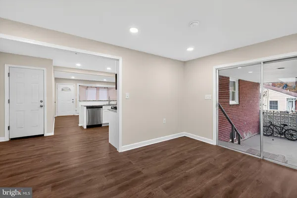 a view of a kitchen with wooden floor and a kitchen