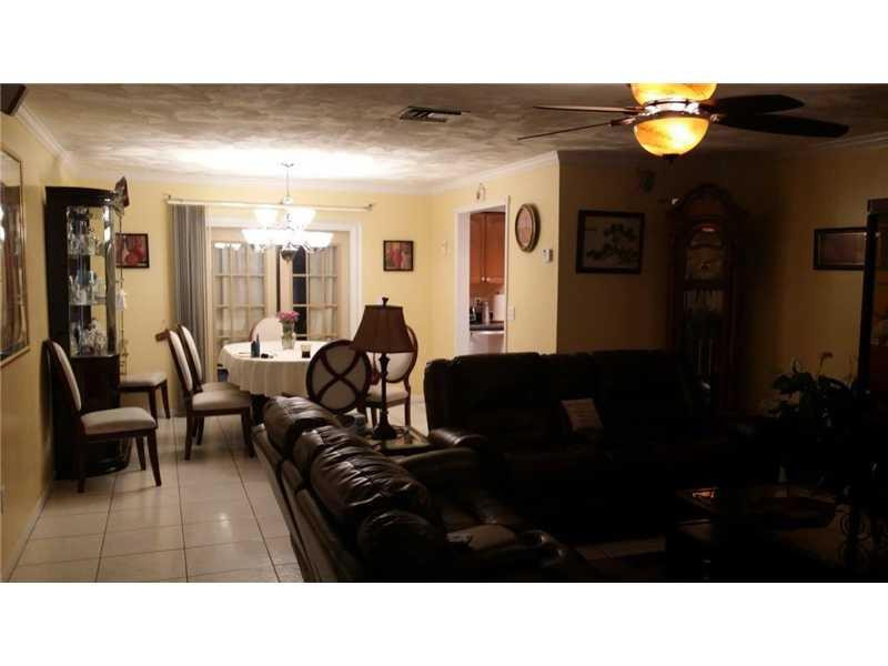22173 Southwest 61st Avenue Boca Raton, FL 33428 - Photo 3 of 17 a living room with furniture and a lamp