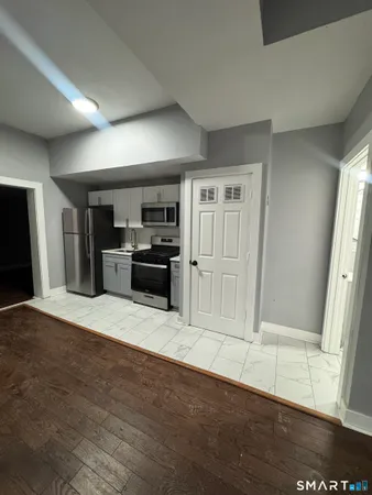 a view of a kitchen with a sink and a refrigerator