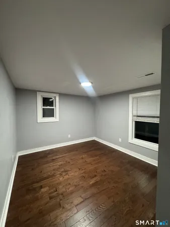 a view of an empty room with a fireplace and a window