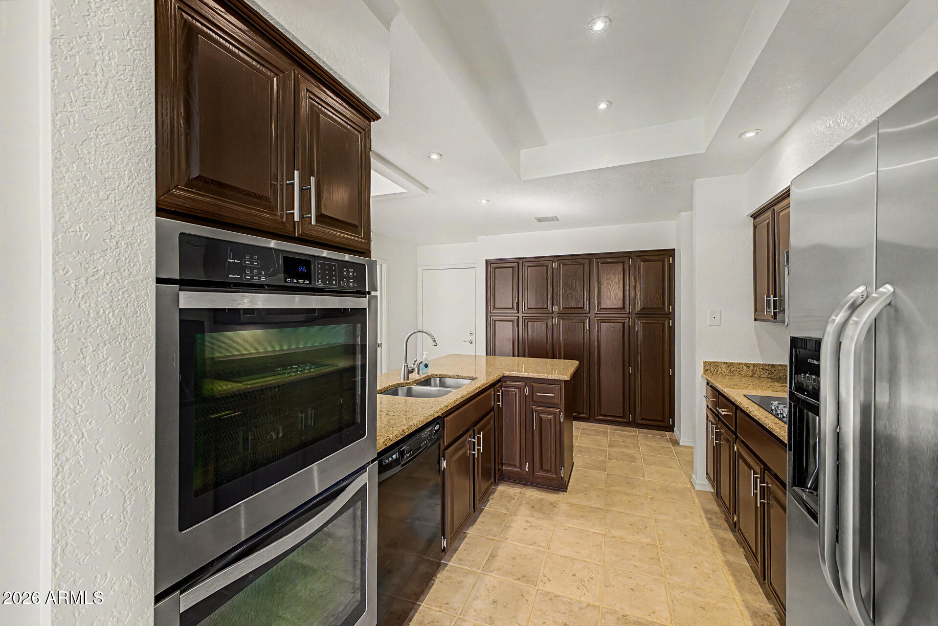 6725 West Utopia Road Glendale, AZ 85308 - Photo 9 of 27 a kitchen with granite countertop a refrigerator stove and microwave