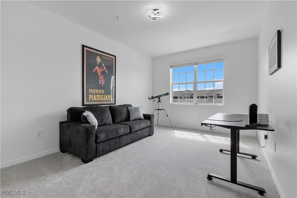 a living room with furniture a air conditioner vent and a window